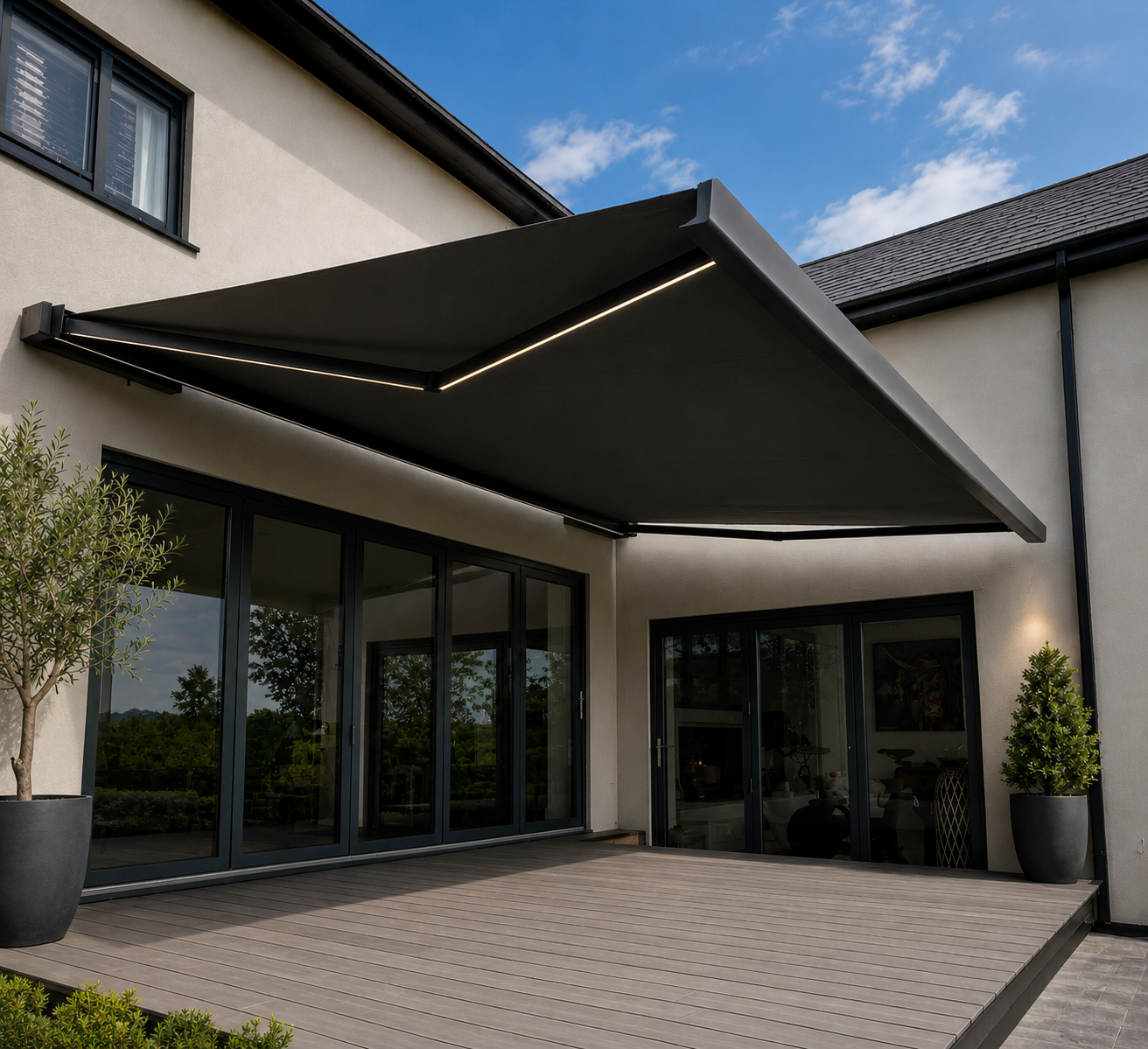 Charcoal retractable awning with integrated LED lighting extended over a modern deck