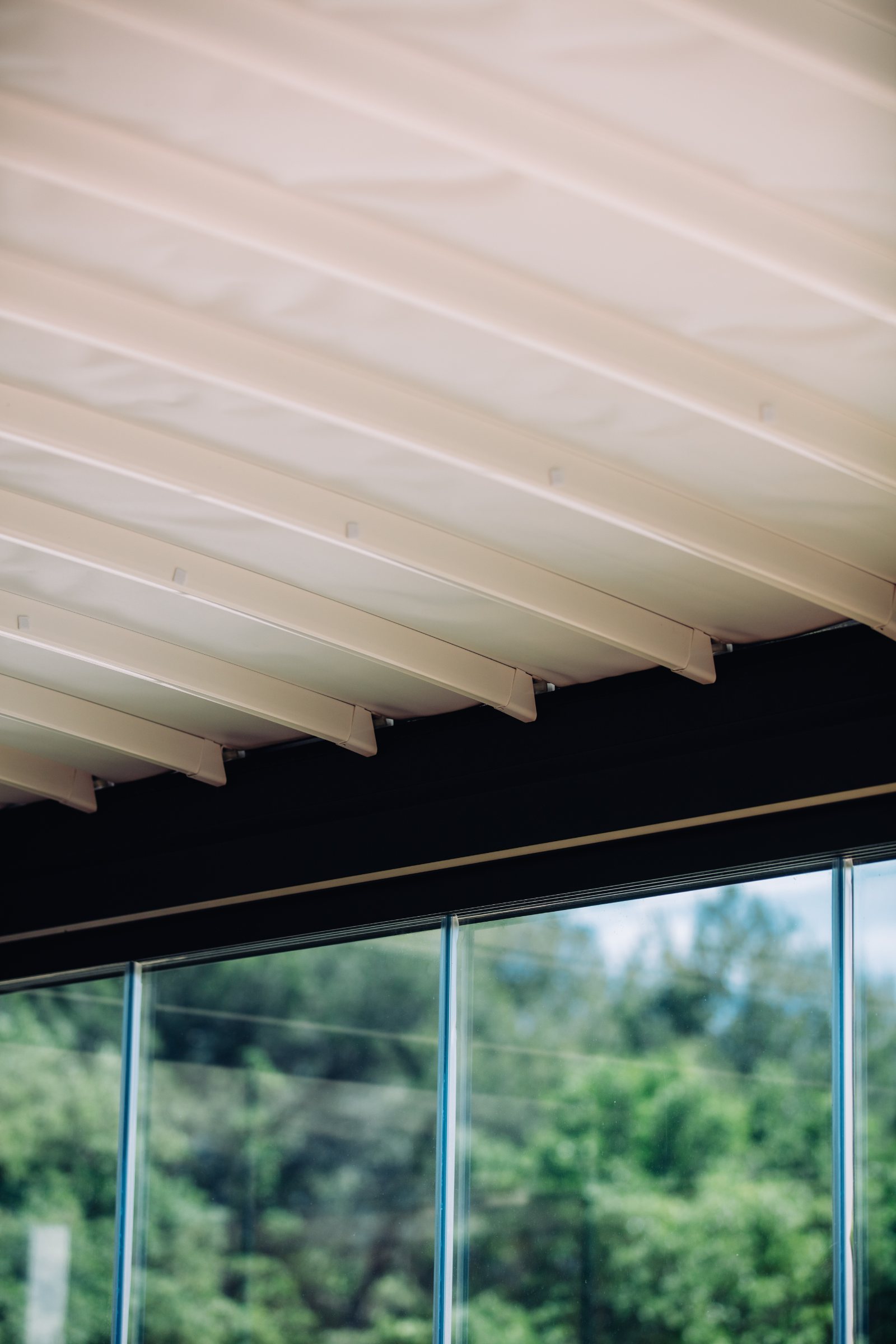 Louvered pergola dining terrace at blue hour with warm interior light